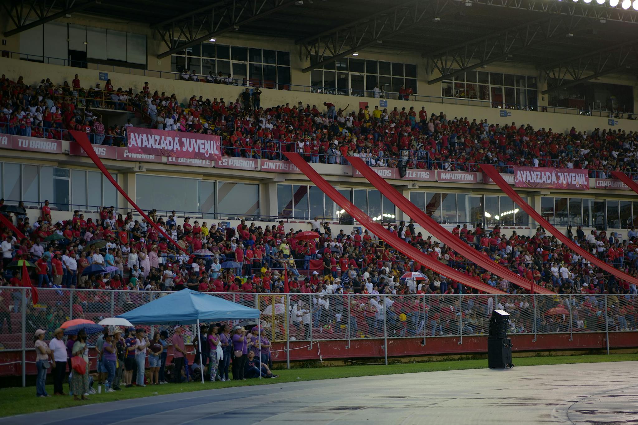 Vibrant scene of an energetic crowd in a stadium, capturing the excitement and enthusiasm of fans in the stands.